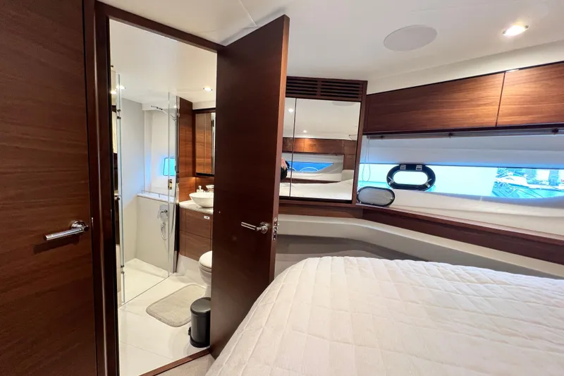  Yacht Photos Pics Luxurious 2021 Princess F55 yacht interior with elegant wood finishes and modern bathroom.
