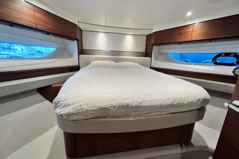  Yacht Photos Pics Luxurious 2021 Princess F55 yacht bedroom with elegant wood accents and large windows.