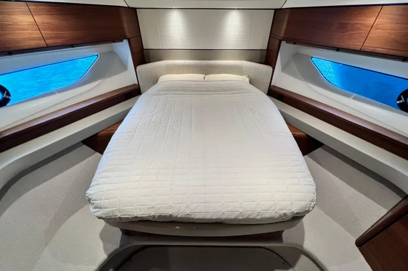  Yacht Photos Pics Luxurious 2021 Princess F55 yacht bedroom with elegant wood accents and large windows.