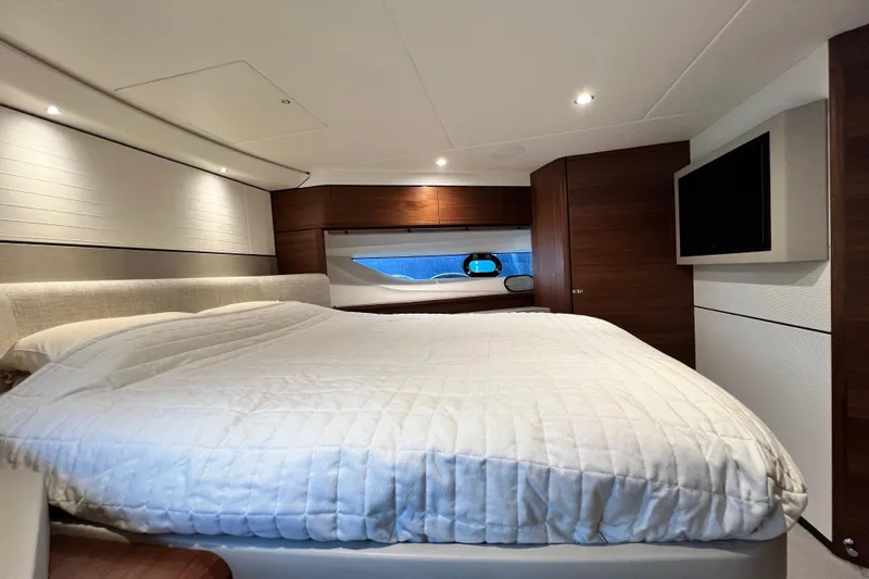  Yacht Photos Pics Luxurious bedroom interior of 2021 Princess F55 yacht with modern design and cozy bedding.