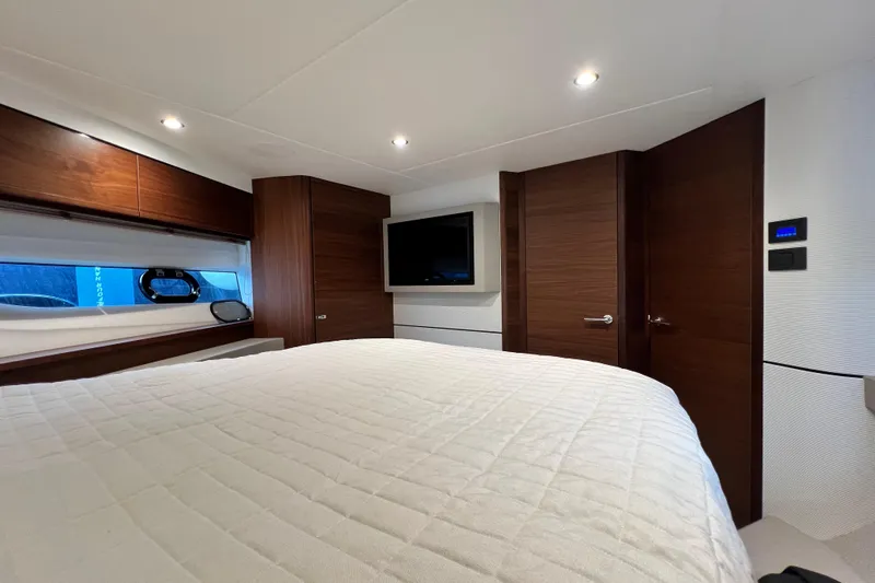  Yacht Photos Pics Luxurious 2021 Princess F55 yacht bedroom with modern wood accents and ambient lighting.