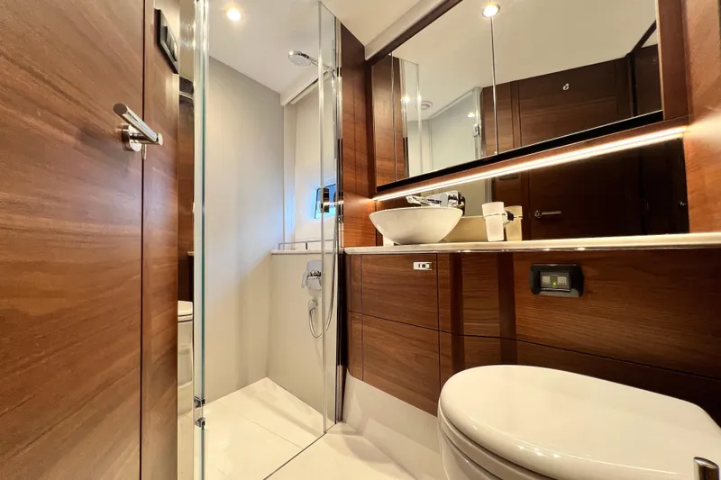  Yacht Photos Pics Luxurious 2021 Princess F55 yacht bathroom with modern wood finish and elegant fixtures.