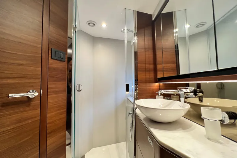  Yacht Photos Pics Luxurious bathroom in 2021 Princess F55 yacht with modern fixtures and wooden accents.
