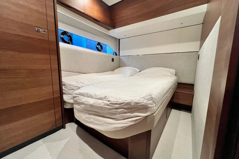  Yacht Photos Pics Luxurious cabin interior of 2021 Princess F55 yacht with twin beds and elegant wood finish.