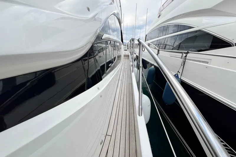  Yacht Photos Pics Side view of a 2021 Princess F55 yacht with sleek design and polished railings.