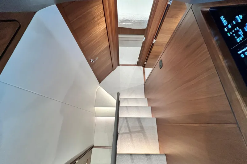  Yacht Photos Pics Interior of 2021 Princess F55 yacht, featuring wooden stairs and modern design.