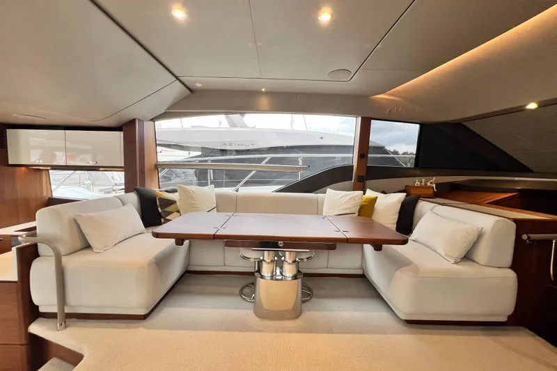  Yacht Photos Pics Luxurious interior of 2021 Princess F55 yacht with elegant seating and wooden table.