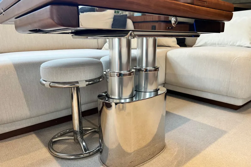  Yacht Photos Pics Luxurious interior of 2021 Princess F55 yacht with modern table and stool design.