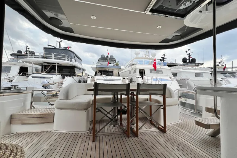  Yacht Photos Pics Luxury yacht marina view from 2021 Princess F55 deck, featuring elegant seating and wooden flooring.