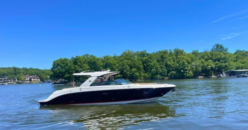  Yacht Photos Pics 2022 Sea Ray 400 SLX boat cruising on a serene lake with lush green trees.