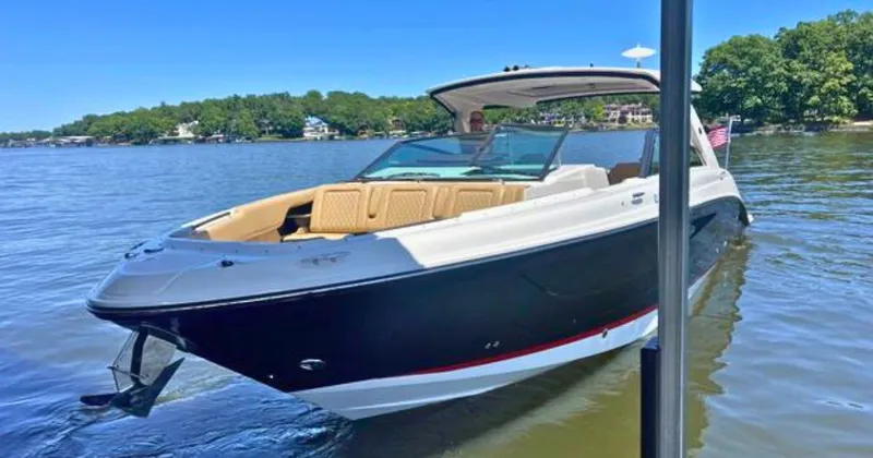  Yacht Photos Pics 2022 Sea Ray 400 SLX boat on a calm lake with lush green shoreline.