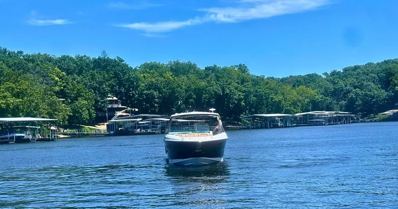  Yacht Photos Pics 2022 Sea Ray 400 SLX boat cruising on a serene lake with lush green surroundings.