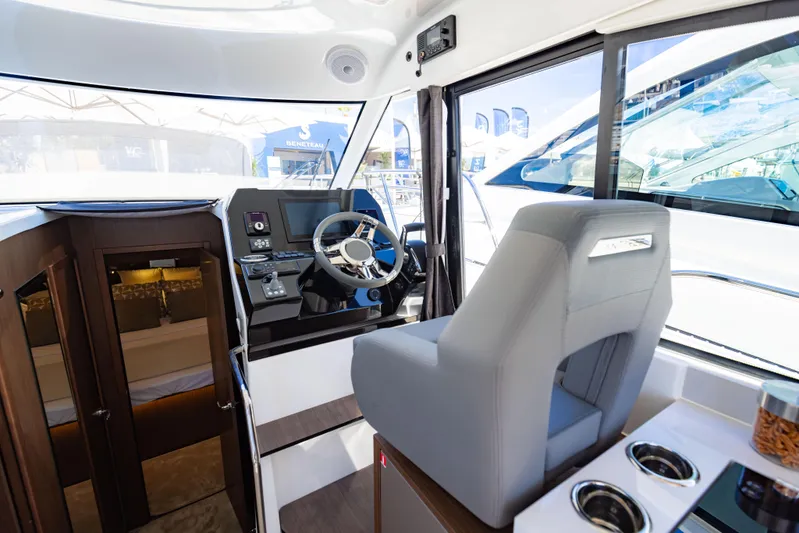  Yacht Photos Pics Interior of 2026 Beneteau Antares 11, featuring helm station and captain's chair.