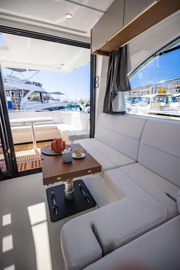  Yacht Photos Pics Luxurious interior of 2026 Beneteau Antares 11 yacht with elegant seating and table.