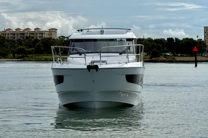  Yacht Photos Pics 2026 Beneteau Antares 11 yacht on calm water, front view.