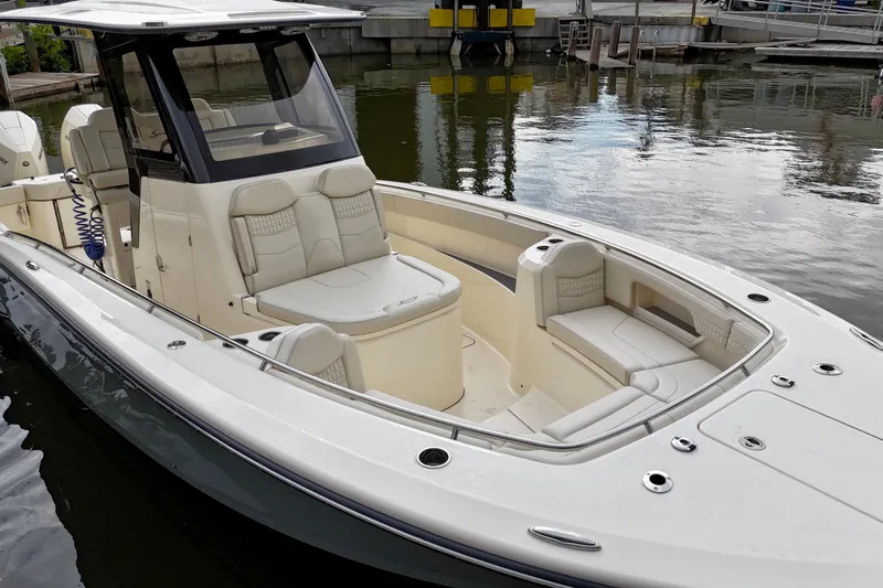  Yacht Photos Pics 2026 Scout 288 LXF boat with luxurious seating, docked in a marina.