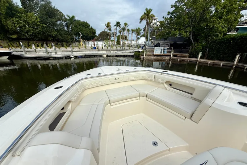  Yacht Photos Pics 2026 Scout 288 LXF boat with spacious seating at a marina.