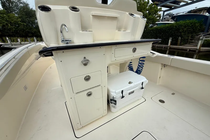  Yacht Photos Pics 2026 Scout 288 LXF boat interior with sink, storage, and Yeti cooler.