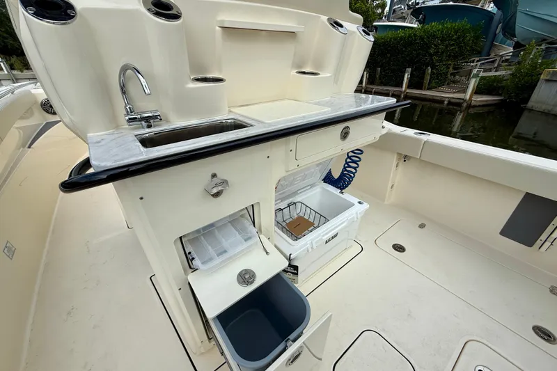  Yacht Photos Pics 2026 Scout 288 LXF boat with sink, storage, and cooler on deck.