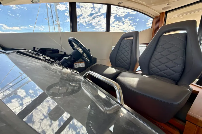 Wine Tyme Yacht Photos Pics Interior of 2016 Sunseeker Predator 57 yacht with leather seats and steering wheel.