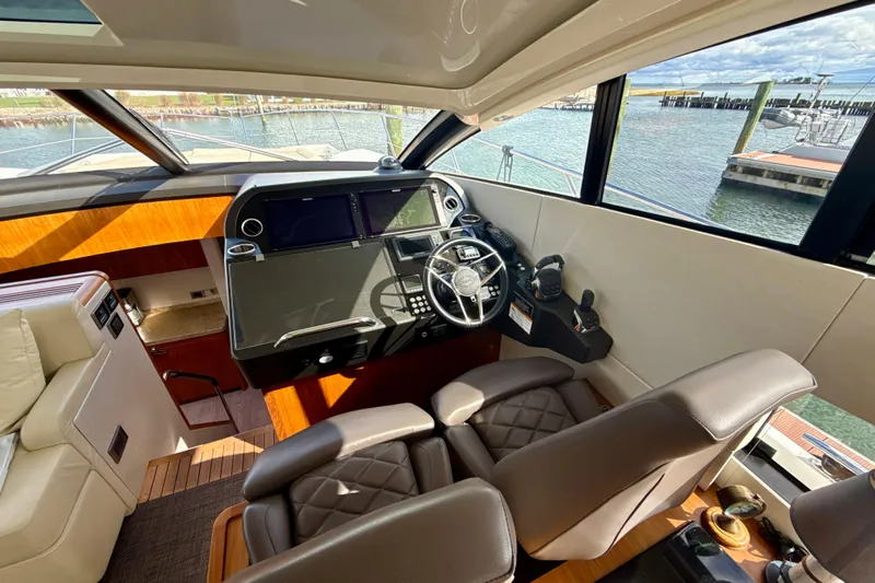 Wine Tyme Yacht Photos Pics Interior helm of 2016 Sunseeker Predator 57 yacht with luxurious seating and controls.