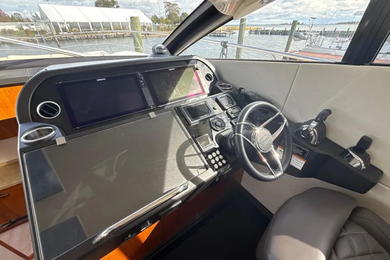 Wine Tyme Yacht Photos Pics Helm of 2016 Sunseeker Predator 57 yacht with modern navigation controls and steering wheel.