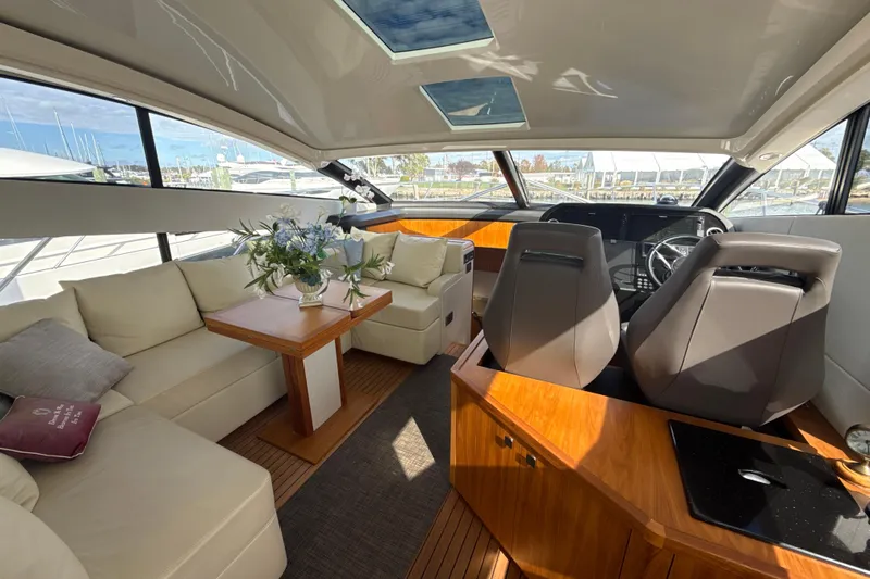 Wine Tyme Yacht Photos Pics Luxurious interior of 2016 Sunseeker Predator 57 yacht with elegant seating and helm.