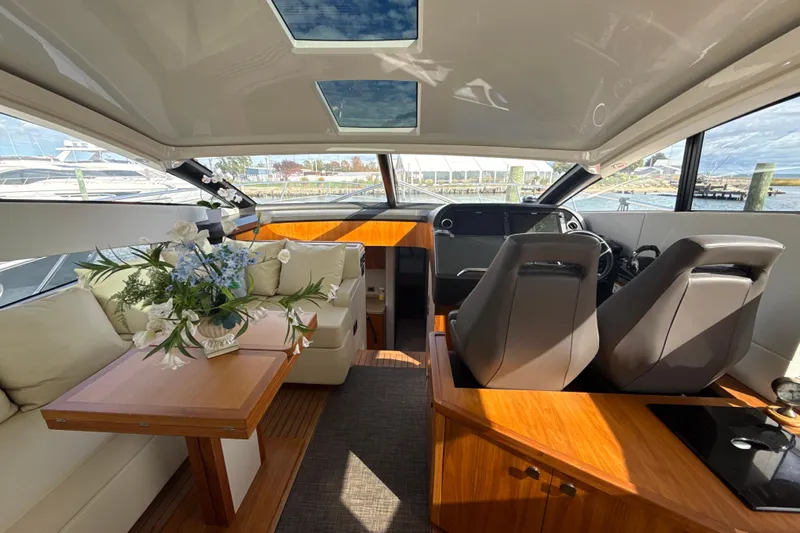 Wine Tyme Yacht Photos Pics Luxurious interior of 2016 Sunseeker Predator 57 yacht with elegant seating and floral arrangement.