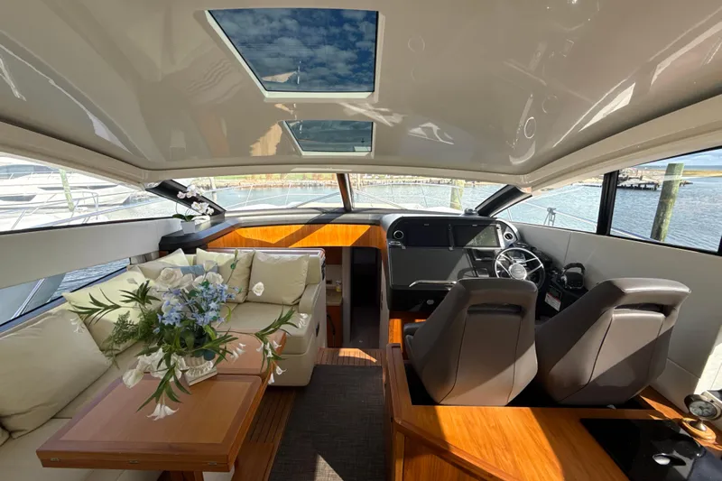 Wine Tyme Yacht Photos Pics Luxurious interior of 2016 Sunseeker Predator 57 yacht with elegant seating and modern helm.
