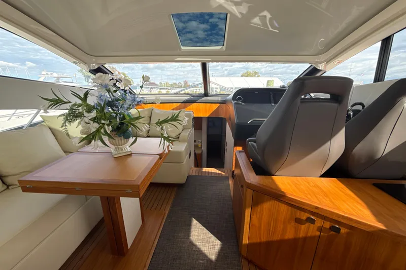 Wine Tyme Yacht Photos Pics Luxurious interior of 2016 Sunseeker Predator 57 yacht with elegant seating and floral arrangement.