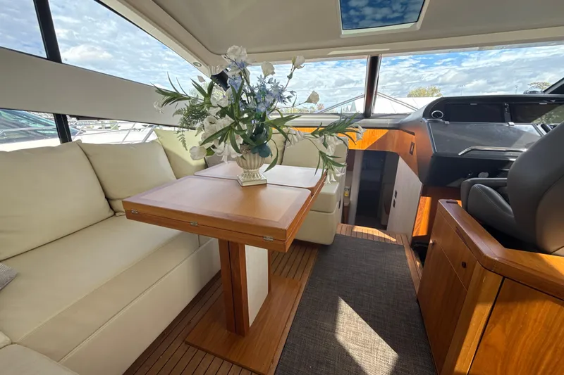 Wine Tyme Yacht Photos Pics Luxurious interior of 2016 Sunseeker Predator 57 yacht with elegant seating and floral arrangement.