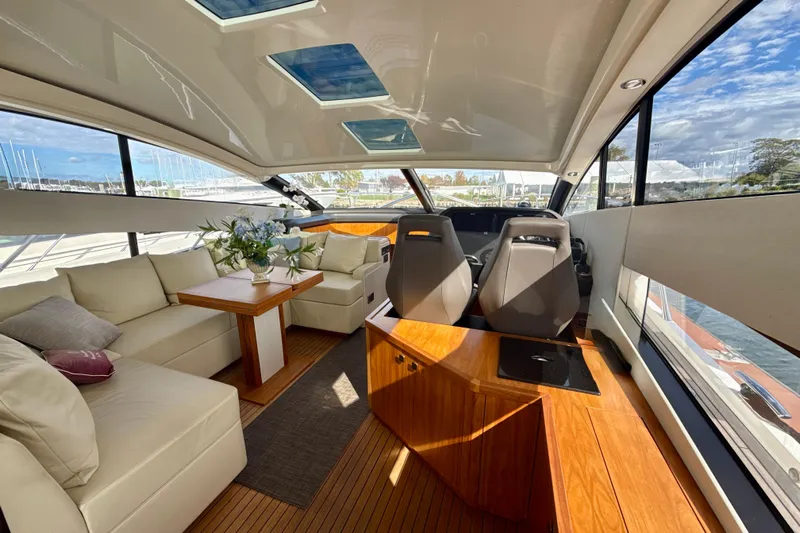 Wine Tyme Yacht Photos Pics Luxurious interior of 2016 Sunseeker Predator 57 yacht with plush seating and panoramic windows.