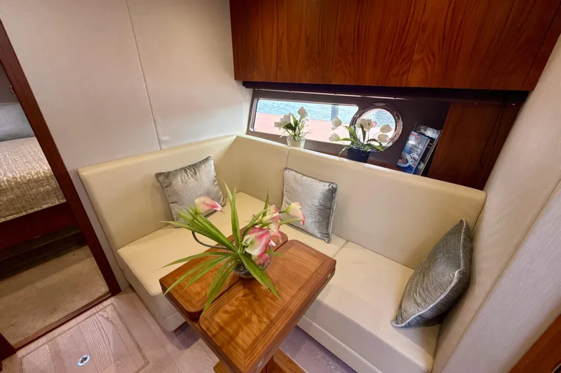 Wine Tyme Yacht Photos Pics Luxurious interior of 2016 Sunseeker Predator 57 yacht with elegant seating and floral decor.