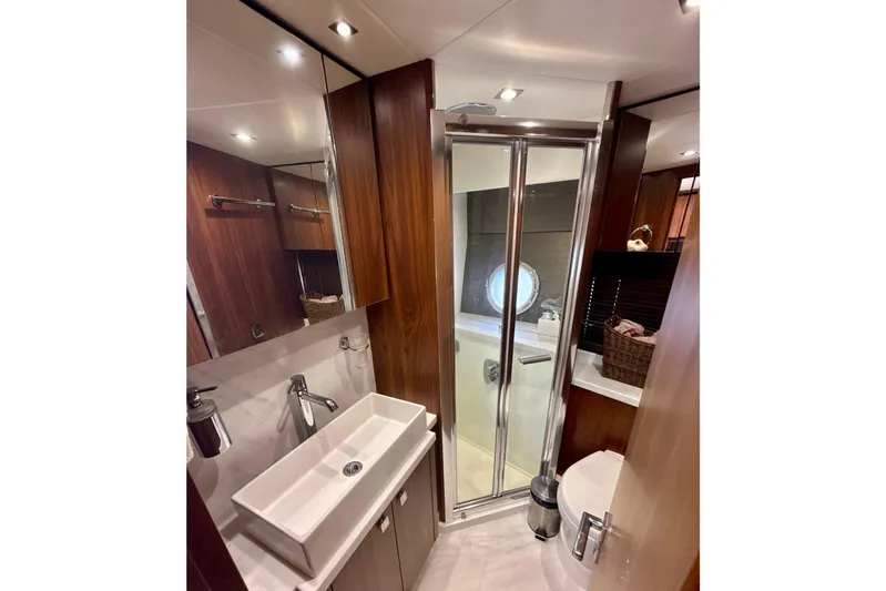 Wine Tyme Yacht Photos Pics Luxurious bathroom in 2016 Sunseeker Predator 57 yacht with modern fixtures and wood accents.