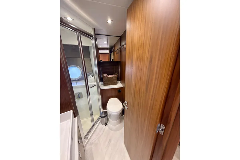 Wine Tyme Yacht Photos Pics Luxurious bathroom in 2016 Sunseeker Predator 57 yacht with wood accents and modern fixtures.