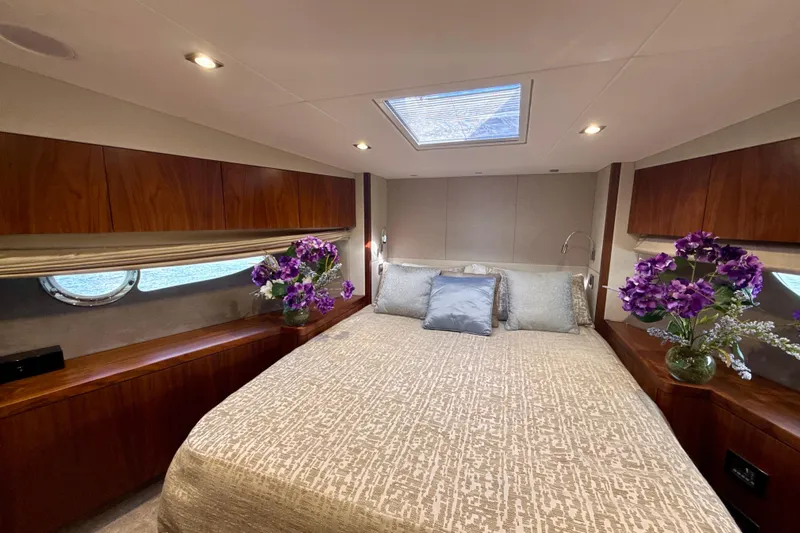 Wine Tyme Yacht Photos Pics Luxurious bedroom interior of 2016 Sunseeker Predator 57 yacht with elegant decor and floral accents.
