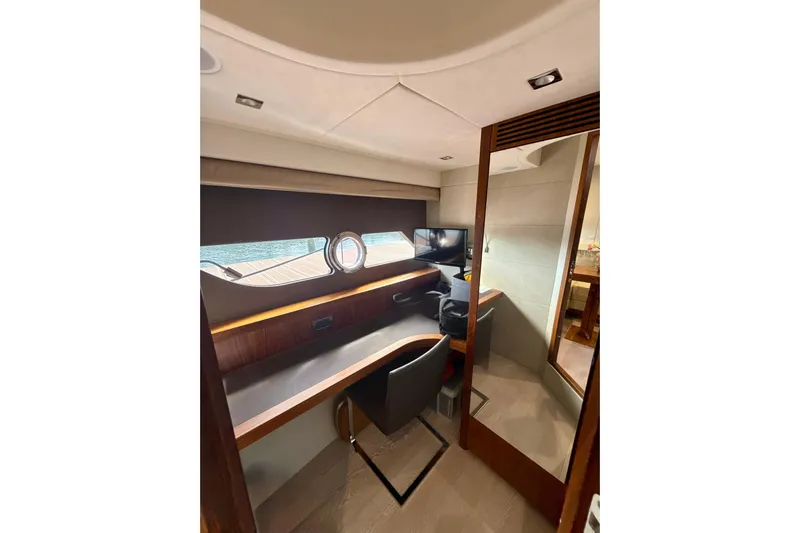 Wine Tyme Yacht Photos Pics Interior of 2016 Sunseeker Predator 57 yacht with desk, chair, and window view.