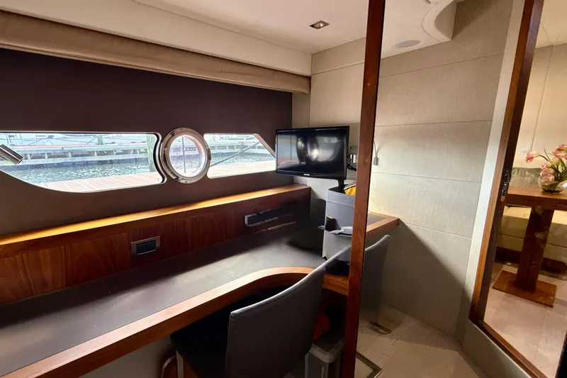 Wine Tyme Yacht Photos Pics Luxurious interior of 2016 Sunseeker Predator 57 yacht with desk and porthole view.