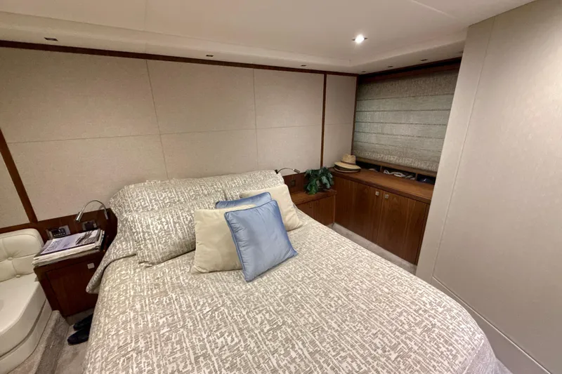 Wine Tyme Yacht Photos Pics Luxurious bedroom interior of 2016 Sunseeker Predator 57 yacht with elegant bedding and wood accents.