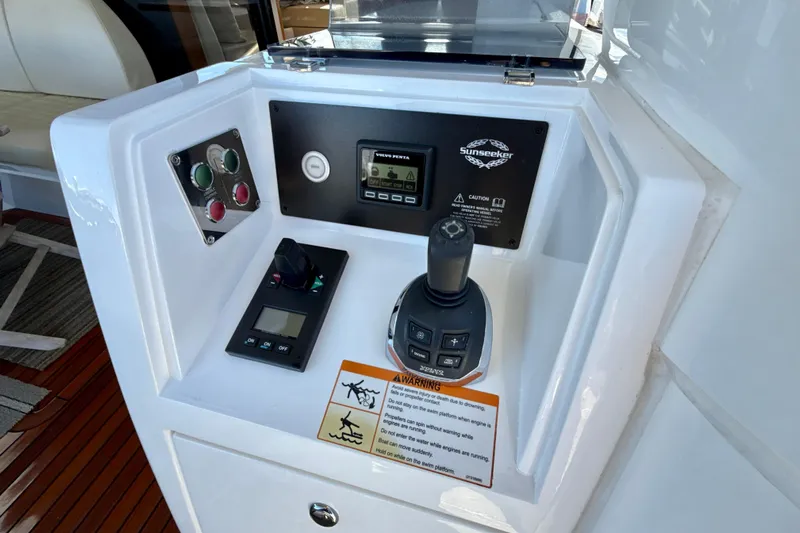 Wine Tyme Yacht Photos Pics Control panel of 2016 Sunseeker Predator 57 yacht with joystick and warning labels.