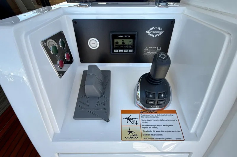 Wine Tyme Yacht Photos Pics Control panel of a 2016 Sunseeker Predator 57 yacht with joystick and warning label.