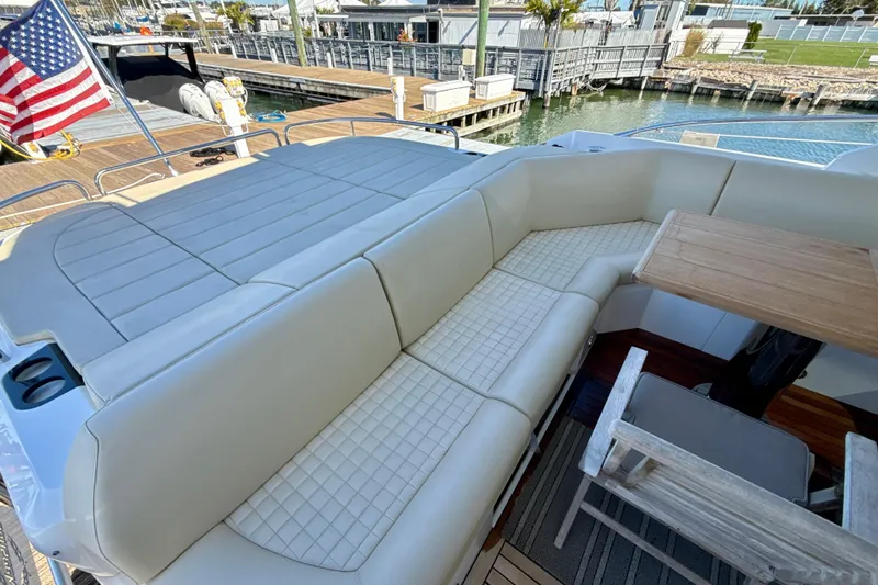 Wine Tyme Yacht Photos Pics Luxurious seating area on a 2016 Sunseeker Predator 57 yacht with American flag.