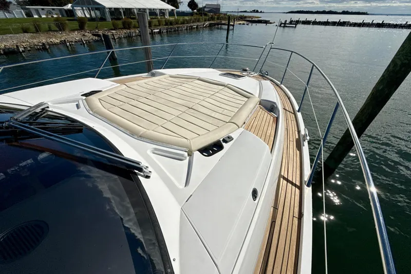 Wine Tyme Yacht Photos Pics 2016 Sunseeker Predator 57 yacht with sunpad, docked by calm waters.