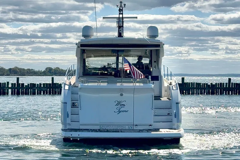Wine Tyme Yacht Photos Pics 2016 Sunseeker Predator 57 yacht on water, rear view with American flag.