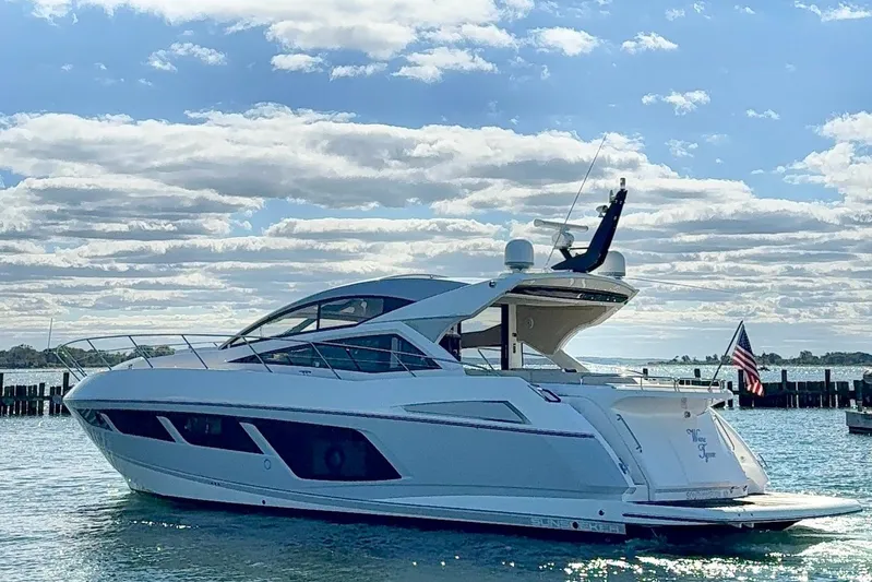 Wine Tyme Yacht Photos Pics 2016 Sunseeker Predator 57 yacht on water under a partly cloudy sky.