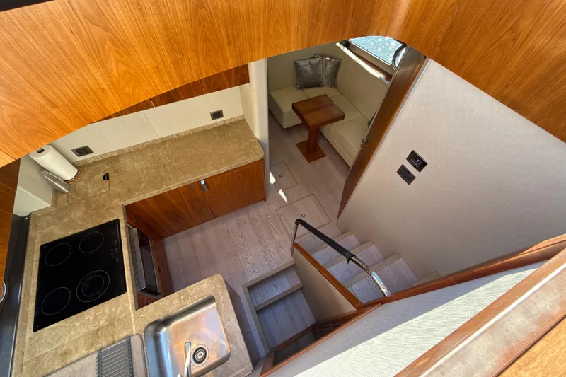 Wine Tyme Yacht Photos Pics Luxurious interior of 2016 Sunseeker Predator 57 yacht with modern kitchen and seating area.