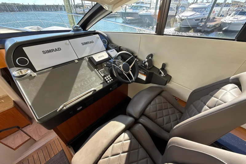 Wine Tyme Yacht Photos Pics Helm of 2016 Sunseeker Predator 57 yacht with Simrad navigation system and leather seats.