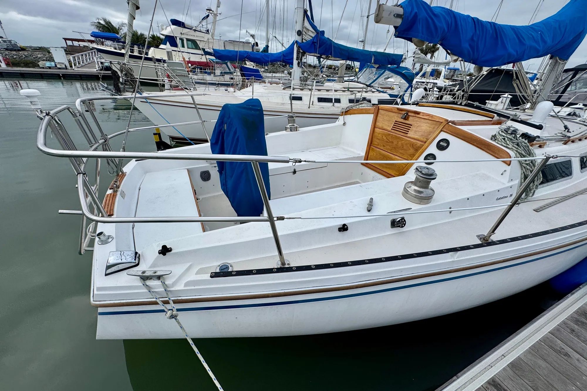 1986 Catalina 36 sailboat docked in marina, featuring spacious cockpit and classic design.