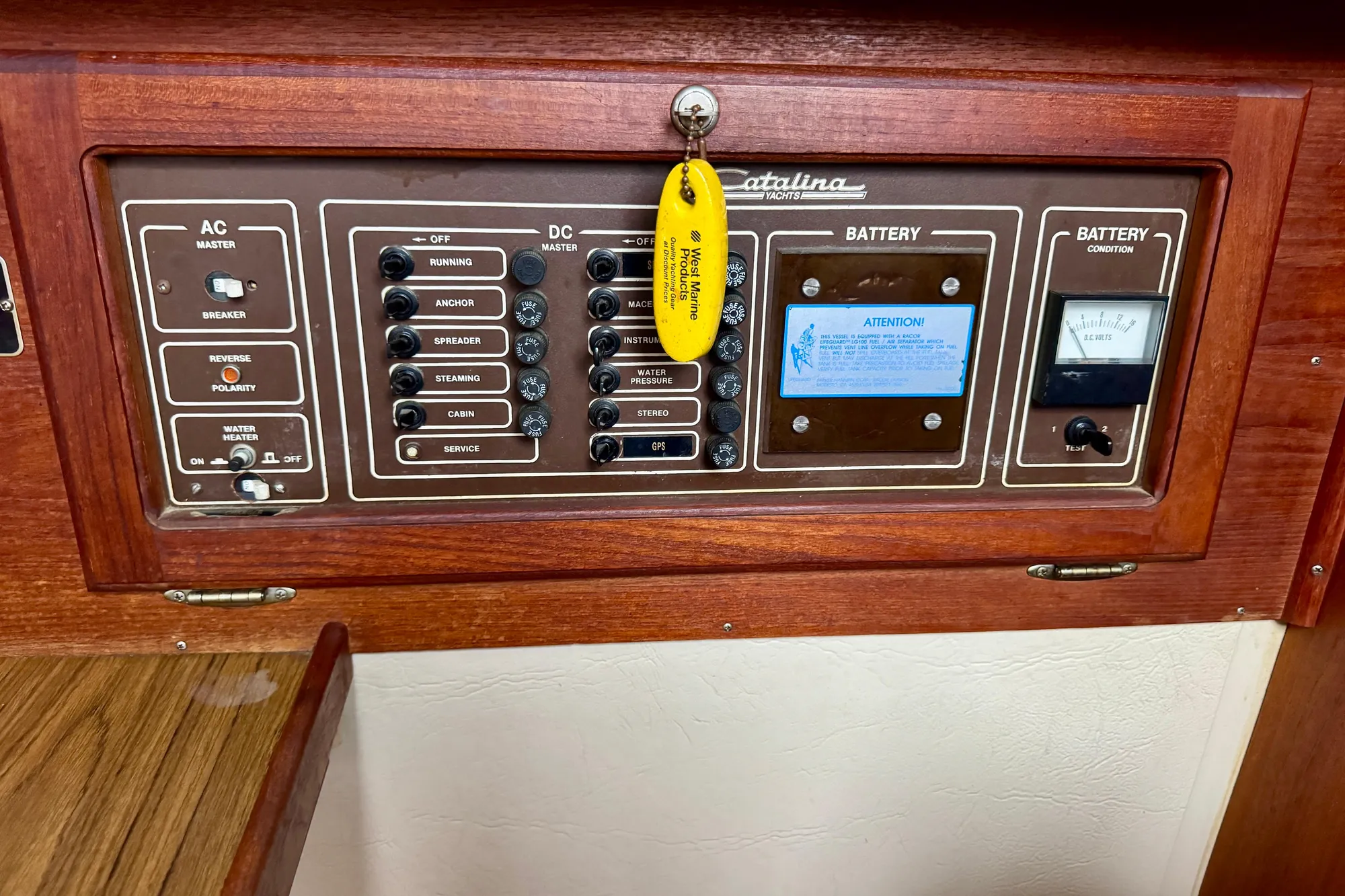 Electrical control panel of a 1986 Catalina 36 yacht with AC and DC switches.