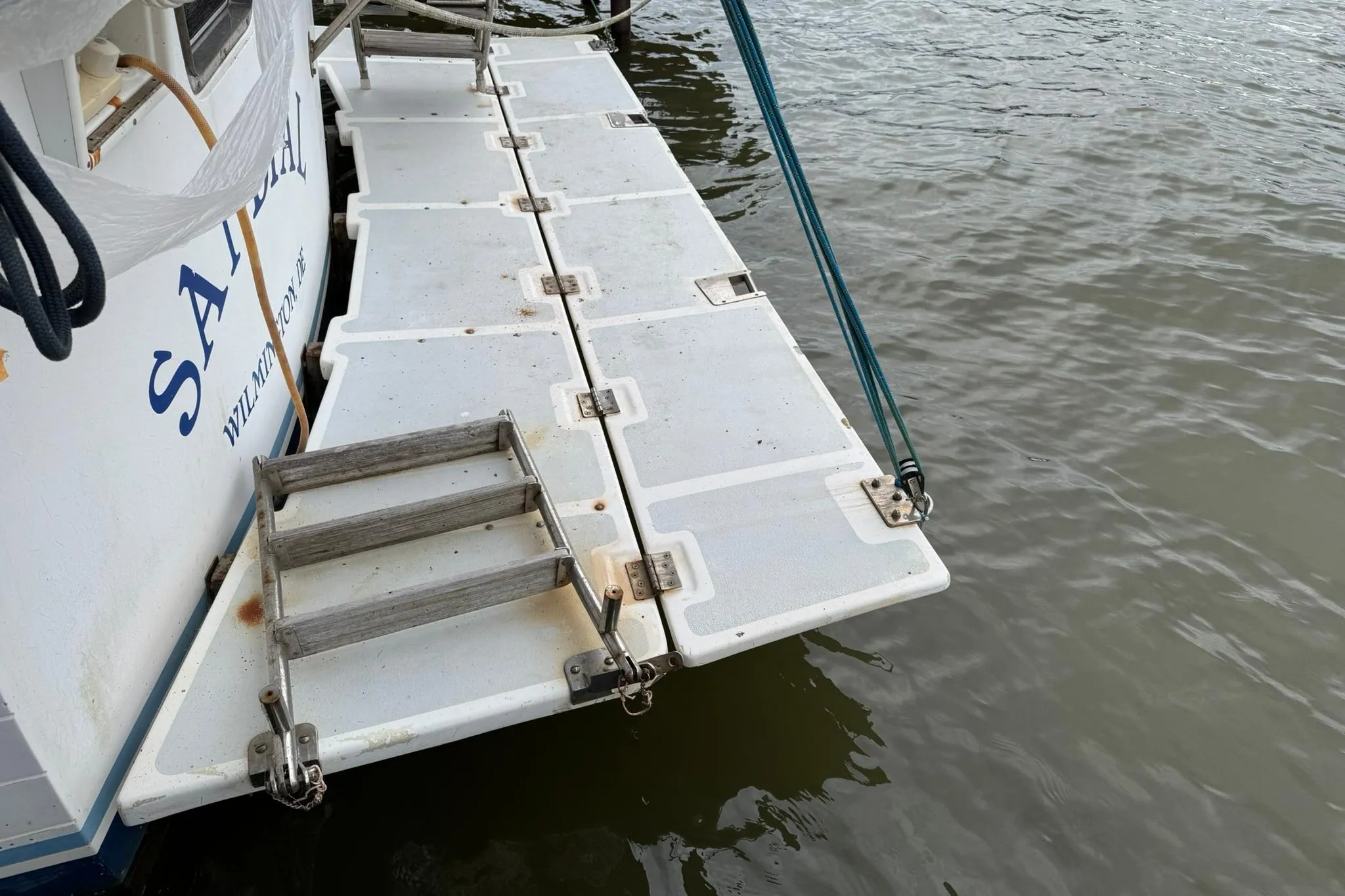 Swim platform on 1991 DeFever 44 boat with ladder and water view.